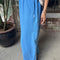 side view of model wearing french blue draped relaxed fit pants