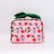 Toiletry bag with cherry lips print, dark green bow handle, brass snap pocket, and mesh interior divider, 3.5 by 5.5 by 8 inches.