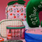 pink and green plastic 'squeaky clean' travel kit with two pots, a funnel, mini spatula, one pump, one spray bottle and label sheet with the contents outside of the pouch surrounded by travel products