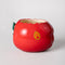 apple ceramic pencil cup laying on its side with 'bite' taken out of the top with 'easy does it' fruit sticker on the side