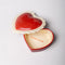 interior of ceramic heart shaped trinket box with white scalloped trim and cursive 'everything' in the inside