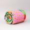 rolled quilted blanket with colorful ill and house print with 'house has my favorite places and faces' typography in the center