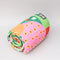 side view of rolled quilted blanket with colorful ill and house print with 'house has my favorite places and faces' typography in the center