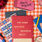 realistic eraser notepad with 'enjoy the messy parts' across the front on a gingham background