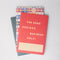 set of three small notebooks: multicolor plaid, simple pink tulip and red with 'for some serious business only!' across the front