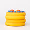 Side view of smiling pancake de stress ball with cute face design