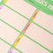 Up close of fruit-themed weekly meal planner pad with colorful illustrations