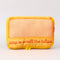 yellow packing cube with red printed 'STOP AND SMELL THE TULIPS'