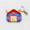 back view of blue house bag charm with red and yellow trim with a dog and cat in the window