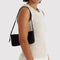 model carrying black pochette