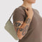 model carrying celadon (sage) pochette