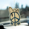 snoopy laying on a blue peace sign air freshener hanging from a mirror