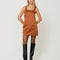 model wearing light brown satin midi tank dress with back bow detail