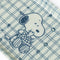 up close of white and blue small trinket tray with snoopy eating strawberries