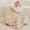 cream and khaki checkered blanket covering model