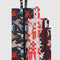 set of three 3D zip set: small plum western cut-outs, medium cream and red cowgirl, and large black and colorful horse cut-out print laying flat