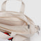 up close of zipper of tan horiztonal zip duck bag with hello kitty face and large 'BAGGU' across the front