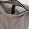 inside of taupe large messenger bag with black strap and closure