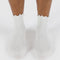 front view of model wearing white lettuce trim socks