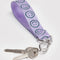 up close of lilac wrist lanyard with green smiley print