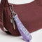 lilac wrist lanyard with green smiley print on a burgundy bag