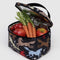 opened black puffy lunch bag with black strap and trim and colorful horse cut out print with veggies inside