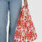 model holding cream standard baggu with red cowgirl print