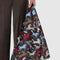 model holding black standard baggu with colorful horse cut-out print