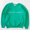 green sweatshirt with white chainstitch farmer's market across the front
