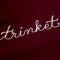 up close of maroon sweatshirt with white chainstitch trinket collector across the front