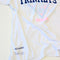 side view of vintage white tee with navy TRINKETS across the front