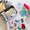 white tin with sketched colorful dogs and matching sticker flakes