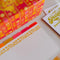 up close of retro 70's print recipe box with gold foil 'RECIPES' across the front and included recipe cards and dividers