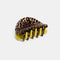 double sided hair claw: translucent brown with black dashes and lime green/yellow reverse side