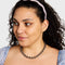 model wearing pink and white checkered wavy acetate headband