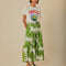 model wearing white maxi skirt with button front detail and palm leaf detail