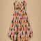 pink midi dress with curved hem, corset bodice, and colorful abstract print
