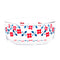 side view of glass storage bowl with white lid and red and blue flower design