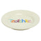 side view of cream dish with colorful 'Tzotchke' across the front