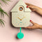model holding cream house shaped cuckoo clock with rainbow dial and teal trim