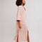 sideview of model wearing pink long robe with bright pink trim