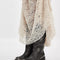 side view of model wearing black distressed leather pull-on tall boots