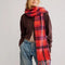model wearing red scarf with pink and purple stripes and beading detail