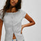 model wearing grey short sleeve ribbed top with scalloped detail on the neckline and sleeves and has a button front