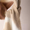 up close of cream brown and tan oversized scarf with thick fringe on the end