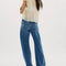 back view of model wearing low rise dark denim barrel jeans