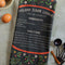 folded green tea towel with holiday sugar cookies with red floral and partridge print