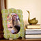 mint fabric scalloped picture frame with peach and white flowers with a photo inside
