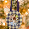 navy and cream gingham round fabric frame ornament hanging on a tree