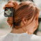 model wearing black and jade granny square medium hair claw